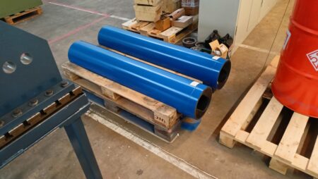 Two blue stators on a wooden pallet